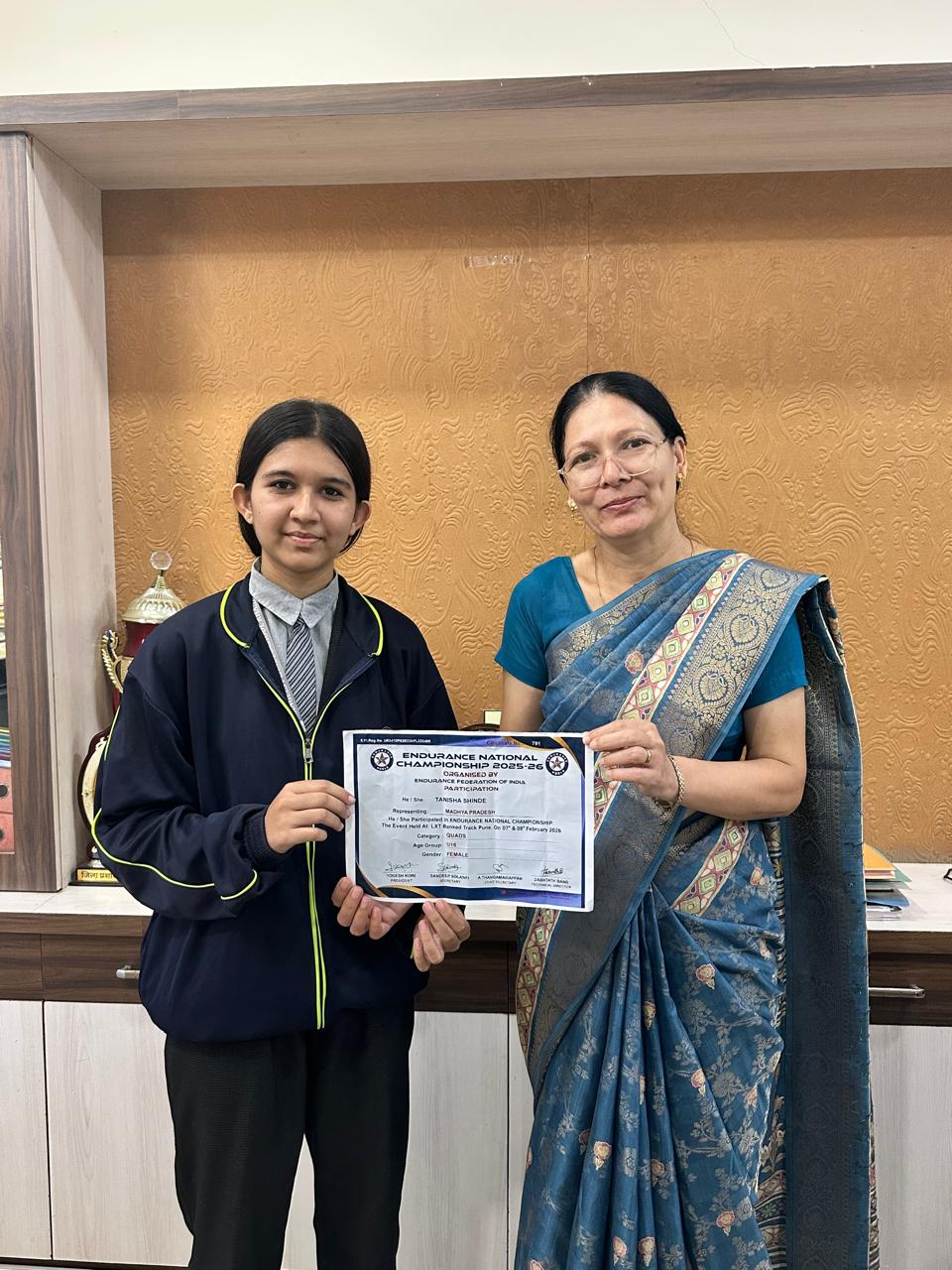 Student receiving recognition from a teacher